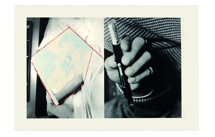Hands holding a photograph and a pen