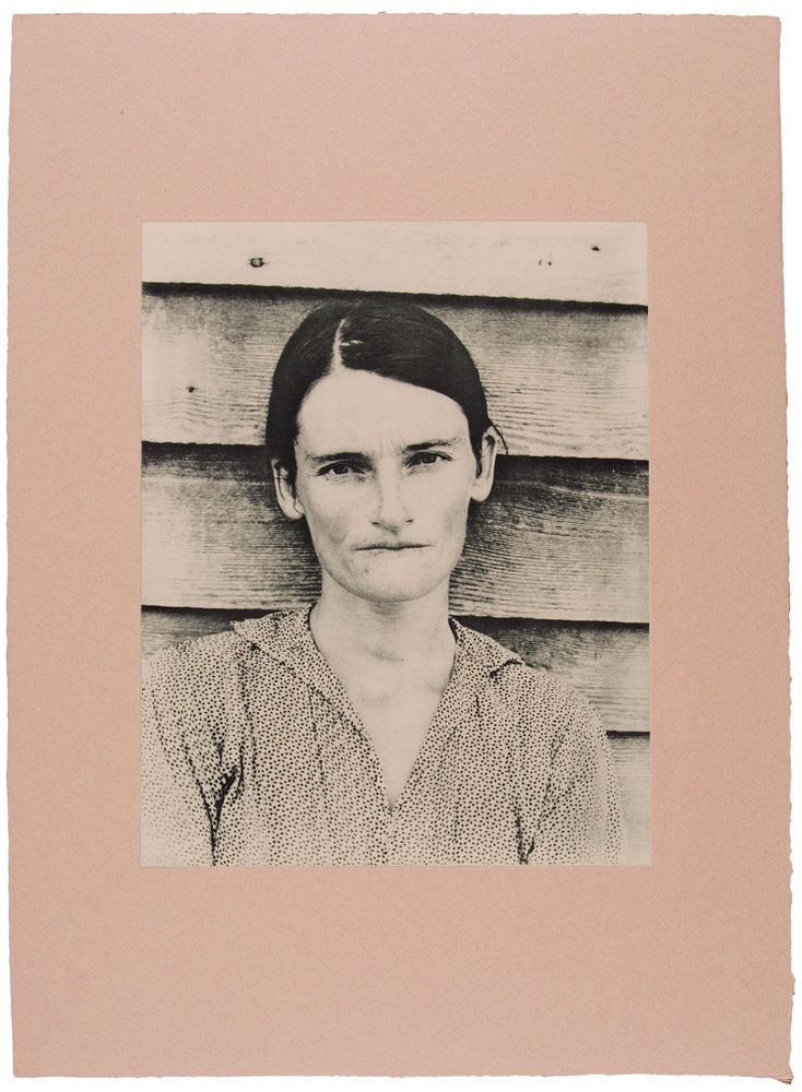 A picture with a pink background. In the centre is a black and white photo of a woman.