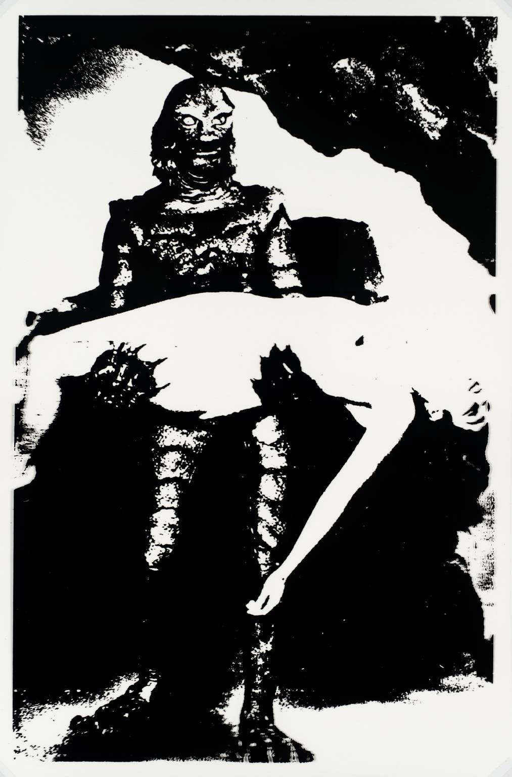 The picture is a black and white image showing a monster holding a person in its arms.