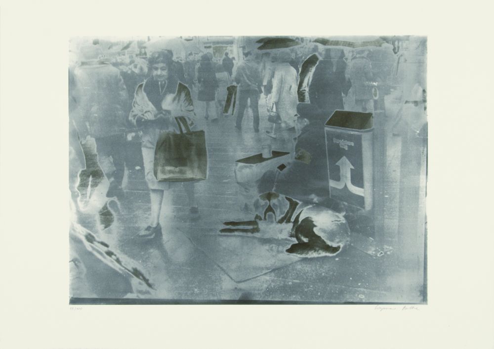 A picture that looks like a faded photograph. The photo shows a man sitting on the floor with his dog.