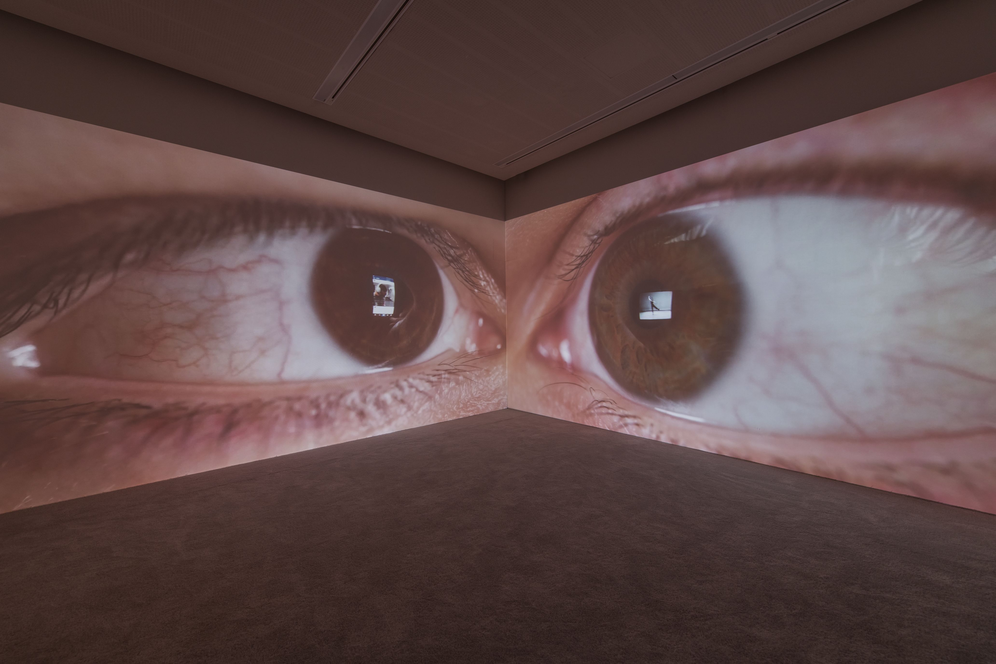 A photo of a room. There are two huge eyes on the walls.