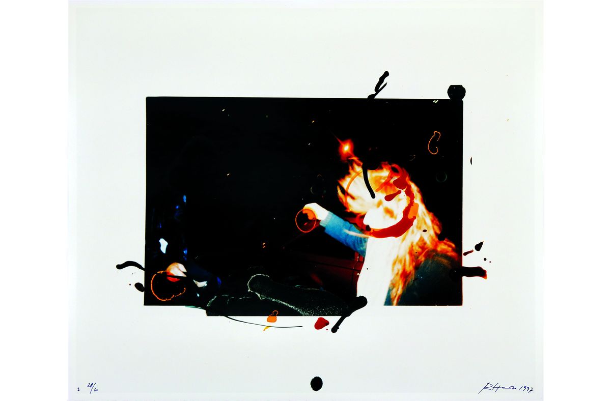 A photo of a red-haired person is positioned in the middle of the picture. There are splashes of different colors on the photo.