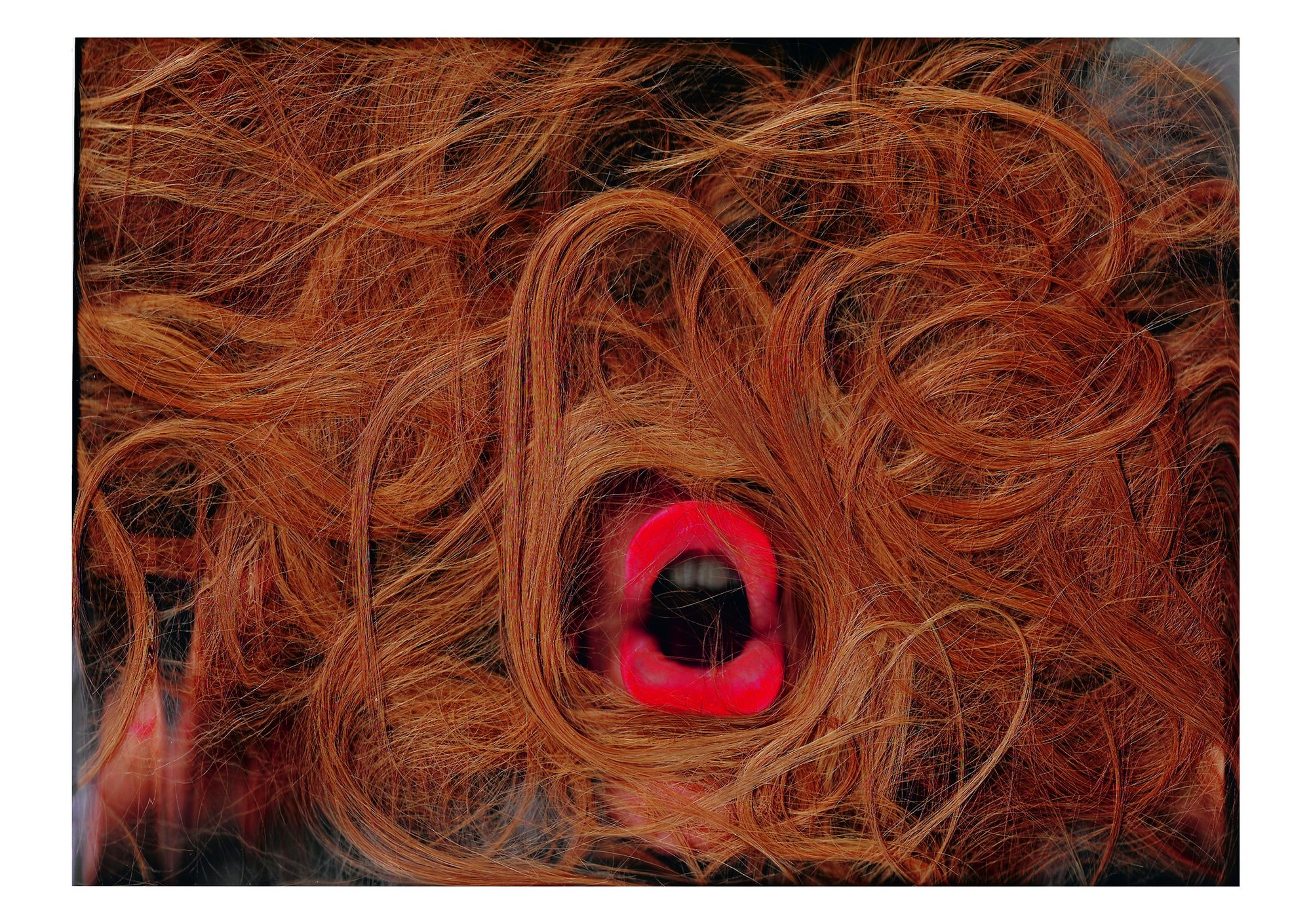 A picture with a mouth in the centre with lots of hair around it. 