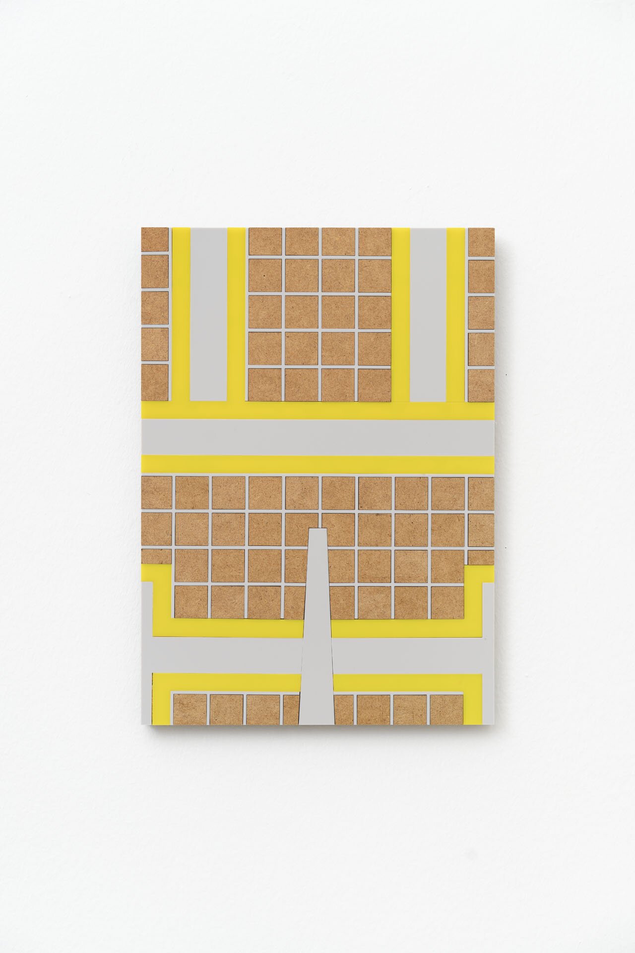 The picture shows a square in the centre on a white background. It consists of many small tiles. The tiles have different colours, such as yellow, grey and brown. 