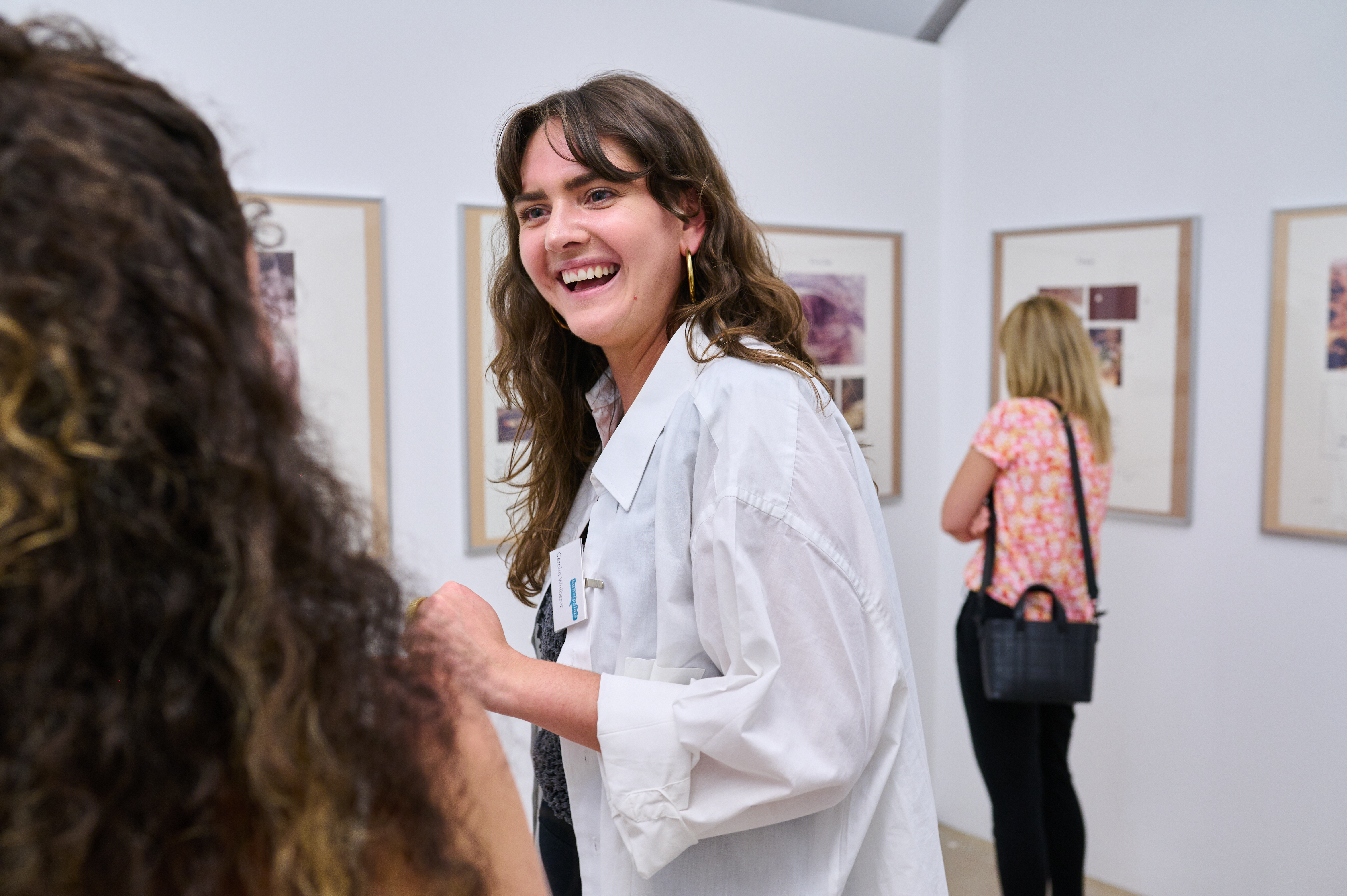 Art educator in conversation with a visitor in the exhibition High Five