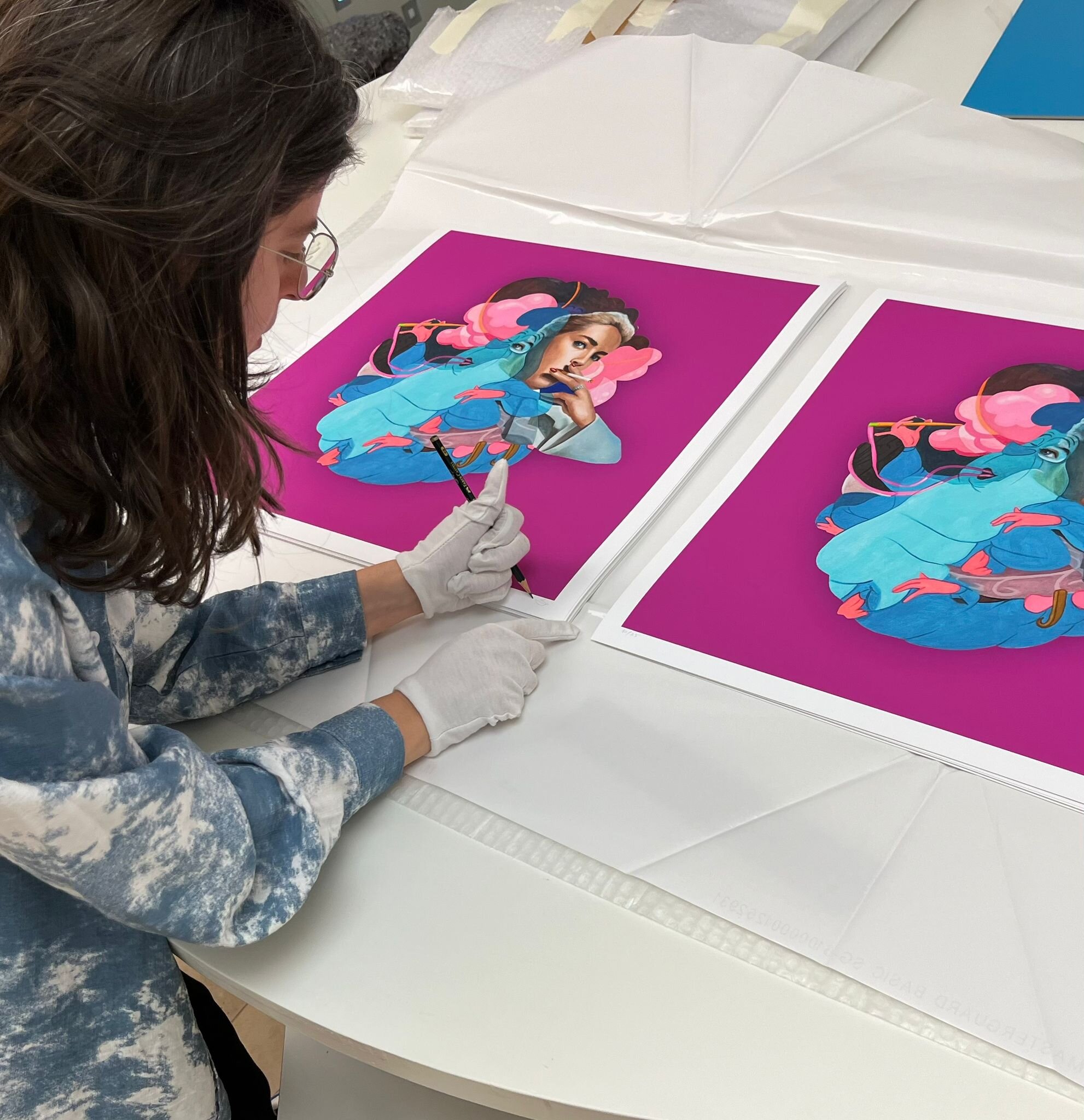 The artist signing the edition